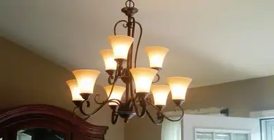 Classic ceiling chandelier installation with warm lighting in Nashville, TN