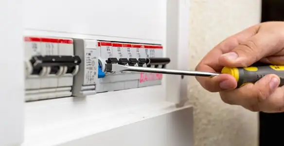 electrical panel upgrade service showing technician adjusting circuit breakers during system upgrade in Nashville, TN