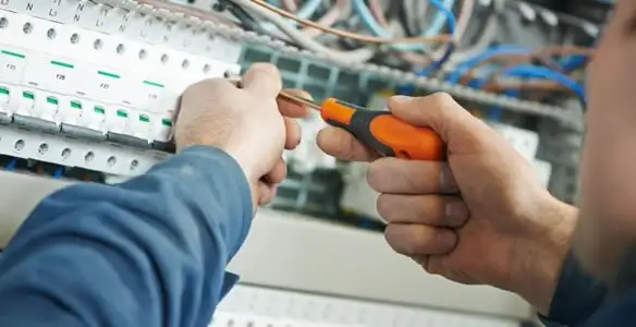 electrical service showing licensed electrician performing electrical panel maintenance and adjustments in Nashville, TN