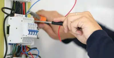 Electrician installing and adjusting circuit breakers in an electrical panel in Nashville, TN
