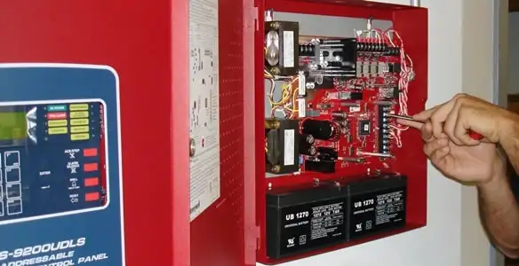 fire alarm installation service showing technician configuring fire alarm control panel in Nashville, TN