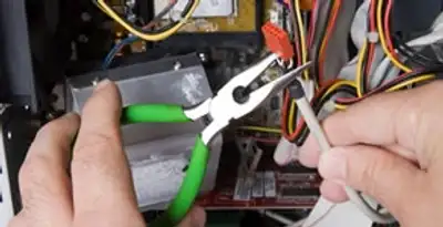 Licensed electrical contractor performing electrical repair with tools in Madison, TN