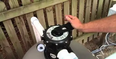pool pumps service showing professional adjustment of pool pump control system in Nashville, TN